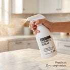 AEMBR Multi Surface Spray 6-Pack in-use lifestyle - hand spraying on marble countertop - 9 surfaces zero compromises