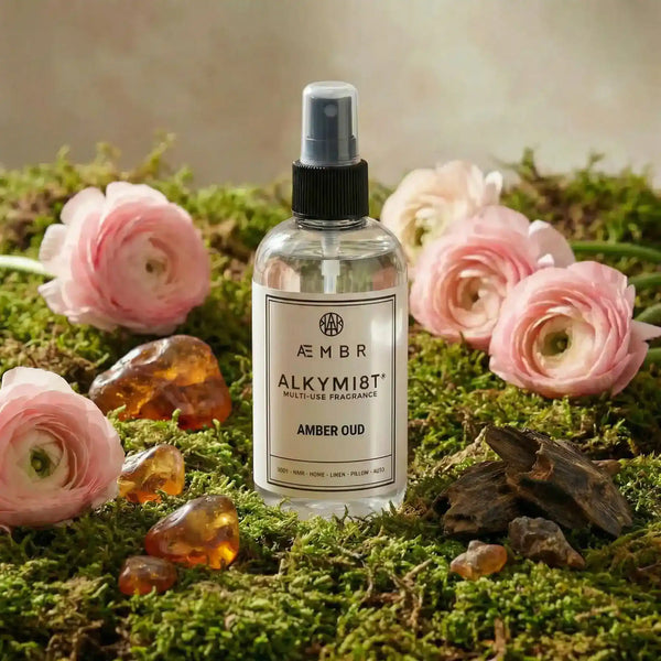Aembr Alkymist® Amber Oud Room Spray, a multi-use fragrance bottle with a sleek design and amber-colored liquid.
