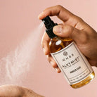 AEMBR Alkymist® Amber Oud Room Spray bottle with a sleek design, showcasing the multi-use fragrance for home and ambiance.