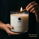Fjord Valkyrie candle in use lifestyle lighting match hands 600 hours coastal calm
