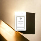 AEMBR Amber Oud luxury coconut wax melts in white packaging on a gold background