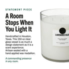 AEMBR The Valkyrie Lavender Haze candle with a sleek glass jar and lavender-colored wax, emitting a calming glow.