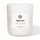 AEMBR Cereal Milk scented candle in white glass, labeled sweet cream and strawberry milk.