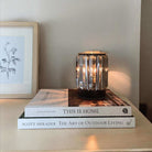 AEMBR crystal wax warmer on bedside table with books and botanical art