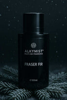 AEMBR ALKYMIST Fraser Fir multi-use fragrance bottle on frosted pine branches