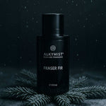 ALKYMIST Fraser Fir multi-use fragrance bottle by AEMBR on fir branches, moody lighting