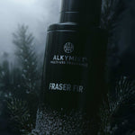 Alkymist Fraser Fir multi-use fragrance bottle with frosted pine branches, non-toxic home scent.