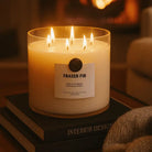 AEMBR Fraser Fir luxury coconut wax candle burning on books in cozy home setting