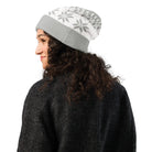 AEMBR grey and white knitted beanie with snowflake pattern, worn by woman in dark sweater