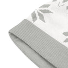 AEMBR knitted beanie close-up, light gray with ribbed cuff and subtle snowflake pattern