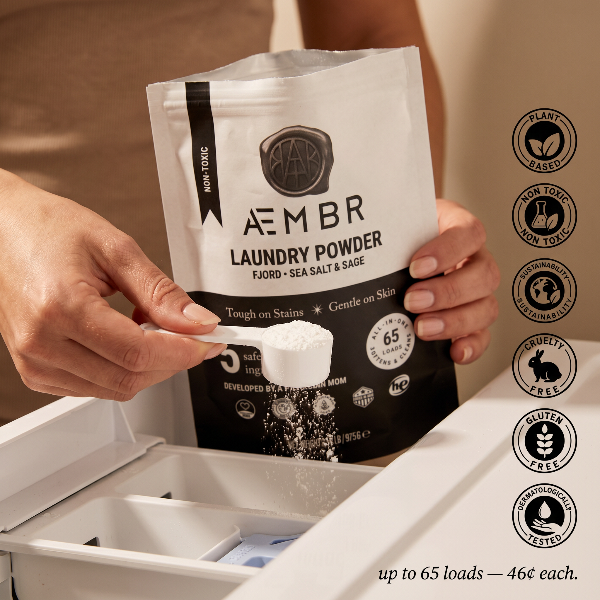 AEMBR Laundry Powder in-use — scoop from pouch into washer dispenser. Up to 65 loads, 46¢ each.