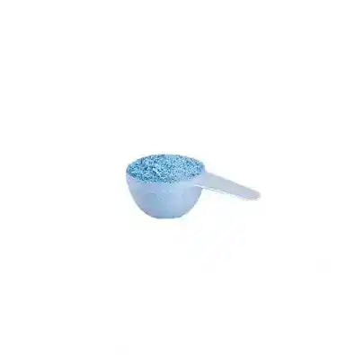 Measuring scoop filled with blue non-toxic laundry detergent powder
