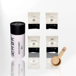 AEMBR Discovery Set with four laundry powder sample packets and wooden scoop on white background