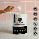 AEMBR non-toxic oxygen boost powder laundry booster with scoop, plant-based, cruelty-free.