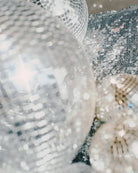 AEMBR sparkling disco balls and sequins reflecting light, bright festive home decor