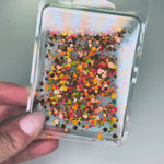 Taylor Swift inspired showgirl era wax melt with teal wax and orange glitter by Aembr