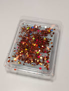 AEMBR wax melt with red glitter in clear clamshell packaging on white background