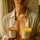 Woman holding AEMBR Salt and Citron non-toxic candles in sunlit room
