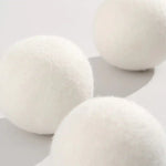 AEMBR scented wool dryer balls on a white background, non-toxic home essentials