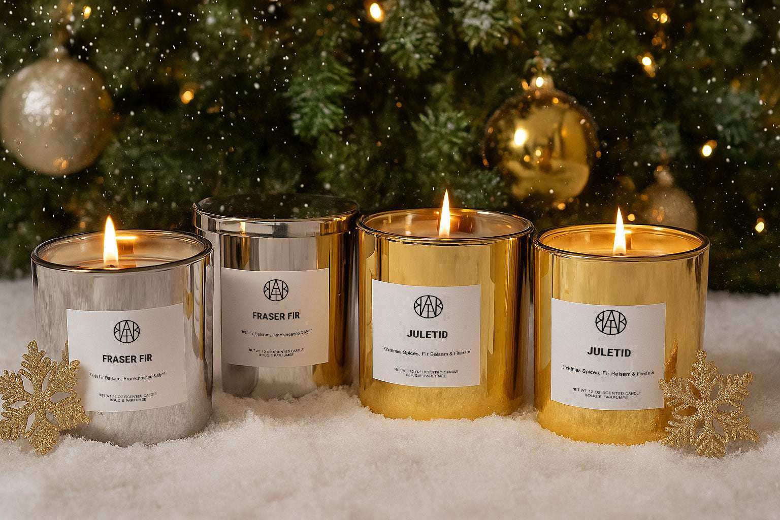 AEMBR silver and gold holiday candles burning in snow with Christmas tree background