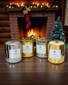 AEMBR silver and gold holiday candles on table with Christmas tree and fireplace in background