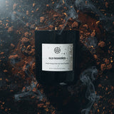Black candle labeled 'Old Fashioned' with smoke effects on a dark background