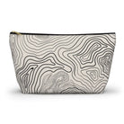 AEMBR travel pouch bag with black topographic line pattern on cream fabric, zip closure.