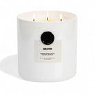 AEMBR The Viking Bibliotek candle with intricate Viking-inspired design in a glass holder on a wooden surface.