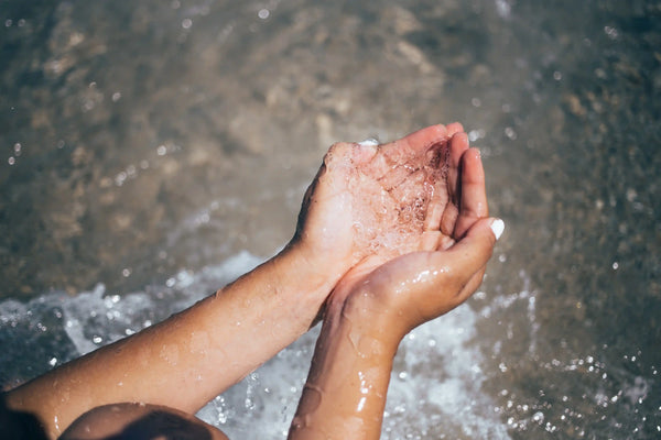 Hands cupping clear water, symbolizing non-toxic, eco-friendly detergent benefits