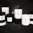 AEMBR black and white non-toxic candles displayed on stands, starry night background.