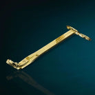 AEMBR gold candle wick trimmer on a dark blue background, luxury candle accessory