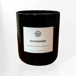 AEMBR Old Fashioned black glass candle with wooden wick, non-toxic, on white background.