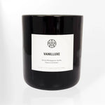 AEMBR Vanilluxe luxury scented candle in black glass jar with minimalist white label