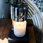 AEMBR non-toxic candle in frosted glass jar on wooden table under modern lamp